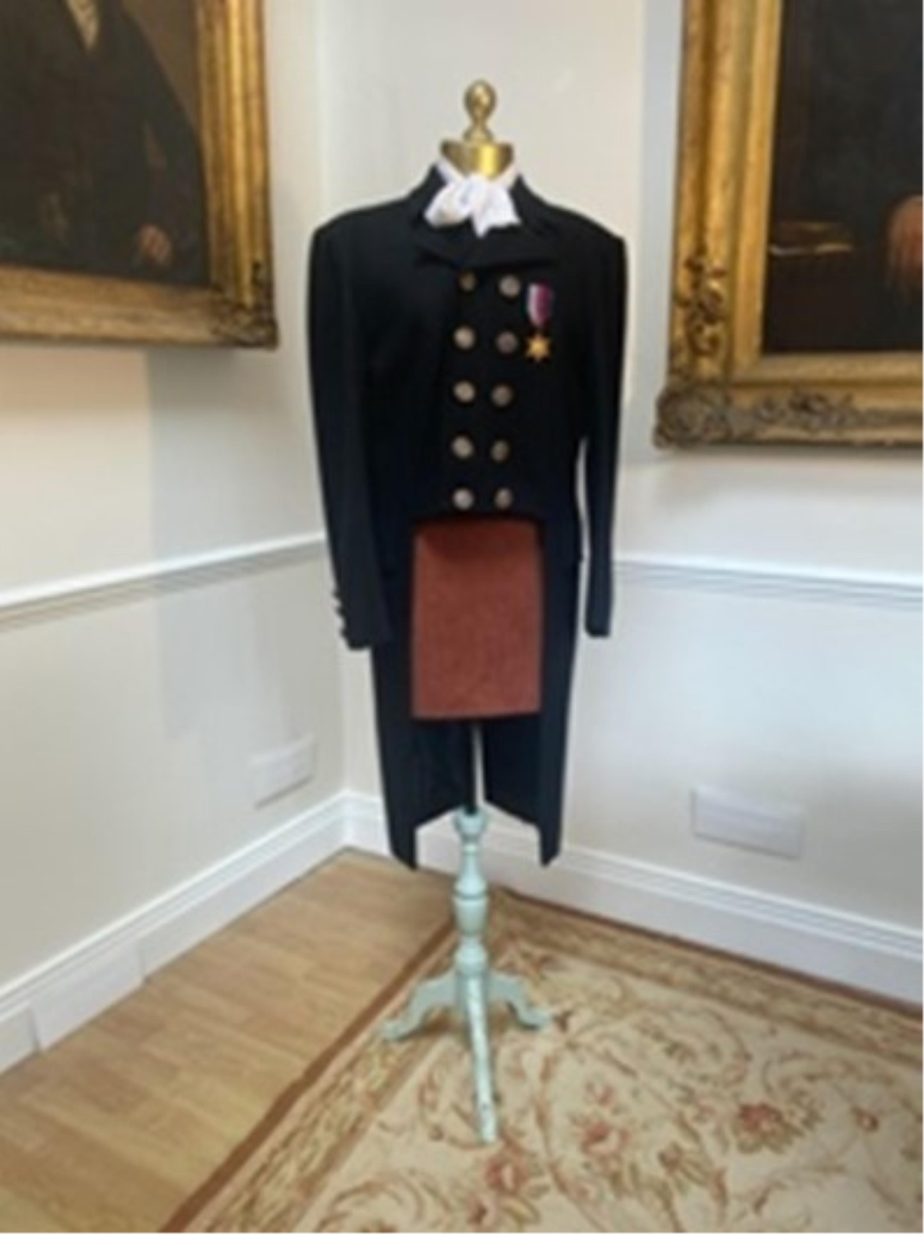 A men’s Regency style military jacket with medal. Size Medium